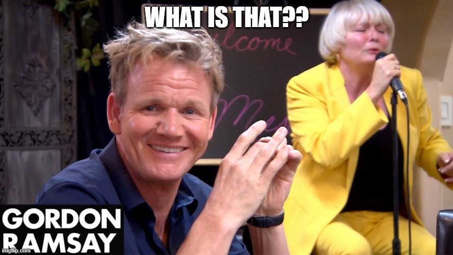 Gordon Ramsay smiling with woman in yellow suit singing in background.
